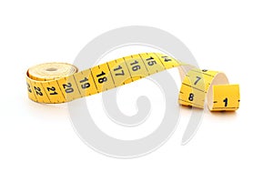 Yellow isolated metric measuring tape isolated on white background. Centimeter, close-up