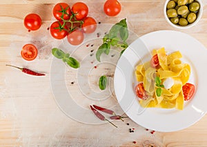 Yellow italian pasta pappardelle, fettuccine or tagliatelle