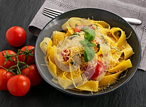 Yellow italian pasta pappardelle, fettuccine or tagliatelle