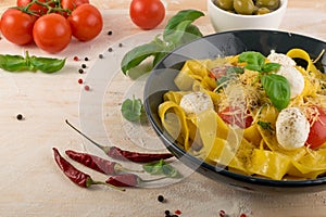 Yellow italian pasta pappardelle, fettuccine or tagliatelle