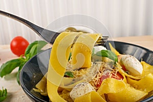 Yellow italian pasta pappardelle, fettuccine or tagliatelle