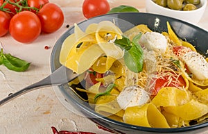 Yellow italian pasta pappardelle, fettuccine or tagliatelle