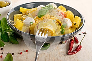 Yellow italian pasta pappardelle, fettuccine or tagliatelle