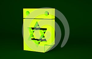 Yellow Jewish calendar with star of david icon isolated on green background. Hanukkah calendar day. Minimalism concept