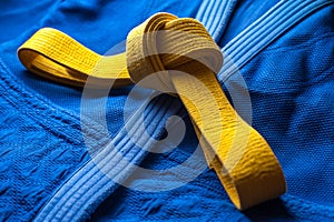 Yellow judo belt tied in a knot photo