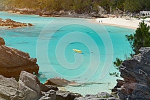 Yellow kayak on blue clean water