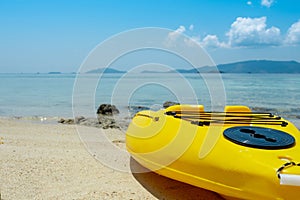 Yellow kayak boat ob beach