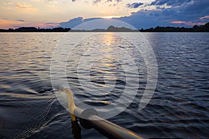 kayak paddle in a beautiful sunset on small Ploner lake with dramatic clouds, Plon, Ploen germany photo