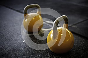 Yellow kettlebells in a crossfit gym