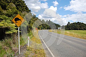 Yellow kiwi bird road sign at roadside