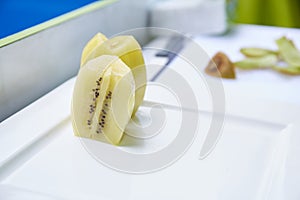 Yellow kiwi sliced on dish