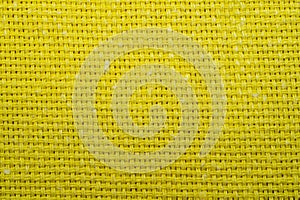 Yellow knitted fabric texture. woven material. textile close up background