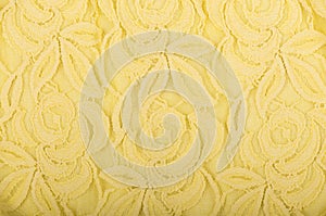 Yellow lace texture with floral pattern on white background.