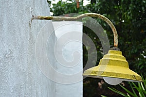 Yellow lamp post with bulb hang outside