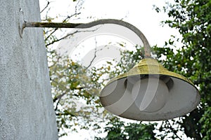 Yellow lamp post with bulb hang outside