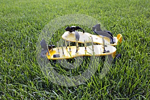 Yellow lawn aerator sandals with nails for lawn cultivation.
