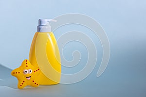 Yellow layout of a children's cosmetic product with a place for a logo and funny rubber toy. Baby shampoo, shower