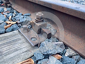 Yellow leaves on the railroad. autumn weather. stones and leaves lie among the rails. rails made of wood and metal, railroad in