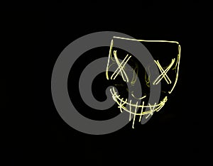 Yellow LED Halloween mask with black background