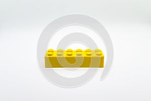 Yellow lego brick or block isolated on white background