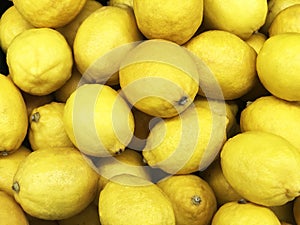 Yellow lemon fruit, Citrus limon L. consist of citric acid compound, yellow texture or background, sell in market shelf. photo