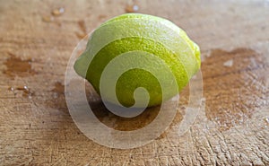 Yellow lemon isolated on a wooden board