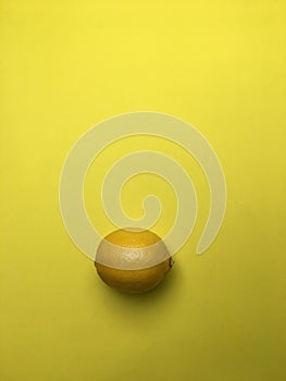 Yellow lemon on yellow background