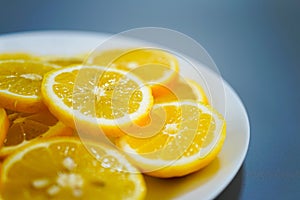 yellow lemons on a plate on a sunny day photo