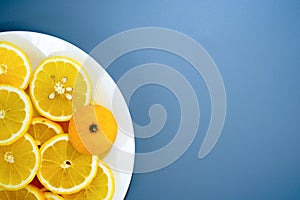 yellow lemons on a plate on a sunny day photo