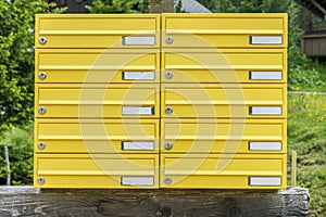 Yellow letterbox made of tin without name in a rural area, Austria