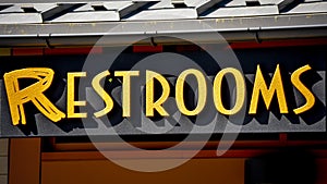 Yellow Lettered Restrooms Sign - Bathroom photo