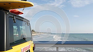 Yellow lifeguard car, ocean beach California USA. Rescue pick up truck, lifesavers vehicle.