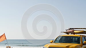 Yellow lifeguard car, ocean beach California USA. Rescue pick up truck, lifesavers vehicle.