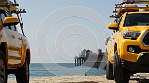 Yellow lifeguard car, ocean beach California USA. Rescue pick up truck, lifesavers vehicle.