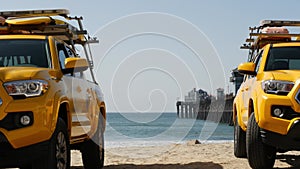 Yellow lifeguard car, ocean beach California USA. Rescue pick up truck, lifesavers vehicle.