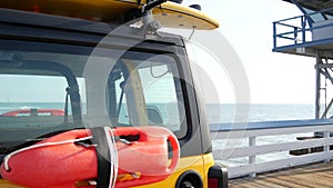 Yellow lifeguard car, ocean beach California USA. Rescue pick up truck, lifesavers vehicle.