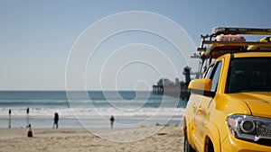 Yellow lifeguard car, ocean beach California USA. Rescue pick up truck, lifesavers vehicle.