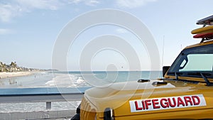 Yellow lifeguard car, ocean beach California USA. Rescue pick up truck, lifesavers vehicle.