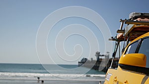 Yellow lifeguard car, ocean beach California USA. Rescue pick up truck, lifesavers vehicle.