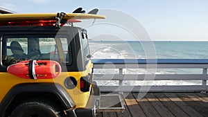 Yellow lifeguard car, ocean beach California USA. Rescue pick up truck, lifesavers vehicle.