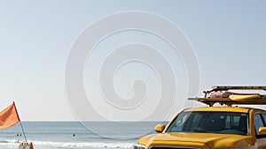 Yellow lifeguard car, ocean beach California USA. Rescue pick up truck, lifesavers vehicle.