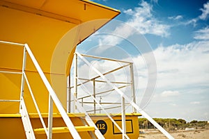 Yellow lifeguard post on an empty beach