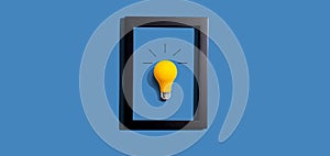 Yellow light bulb inside a frame - inspiration, creativity themes