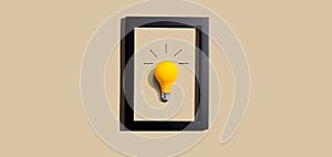 Yellow light bulb inside a frame - inspiration, creativity themes