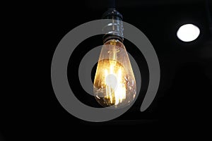 Yellow light bulb isolated on black background 4 central