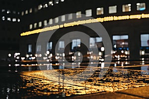 Yellow light reflection in the water in Canary Wharf, London, UK