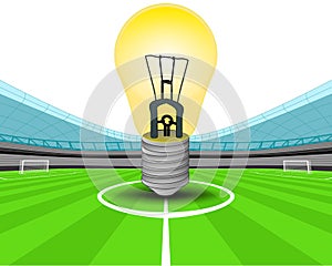 Yellow lightbulb in the midfield of football stadium vector