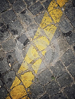 Yellow line marking on cubical stone