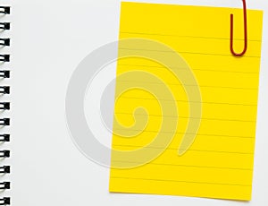 Yellow line memo paper clipped on white notebook