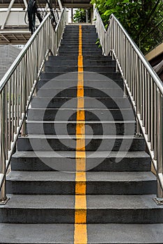 Yellow line and stairs to foot bridge.